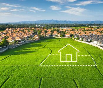 StockImage_Aerial_view_of_a_residential_real_estate_beside_a_green_field